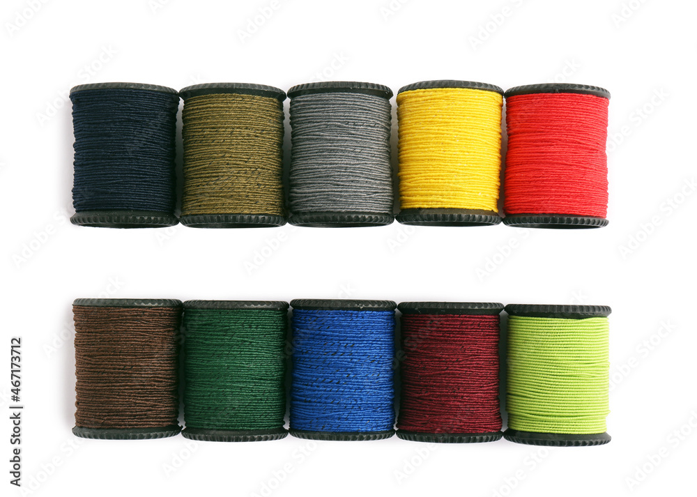 Set of colorful sewing threads on white background, top view Set of colorful sewing threads on white background, top view