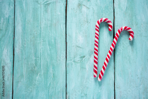 Striped Christmas candy cane on turquoise surface
