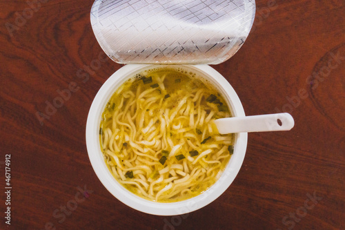instant noodles cup- Unhealthy food with flavoring powder andor seasoning oil. Instant noodle in a plastic cup ready to eat photo