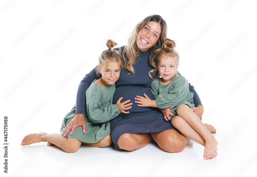 Two cute little sisters on the floor with pregnant mother Two cute little sisters on the floor with pregnant mother