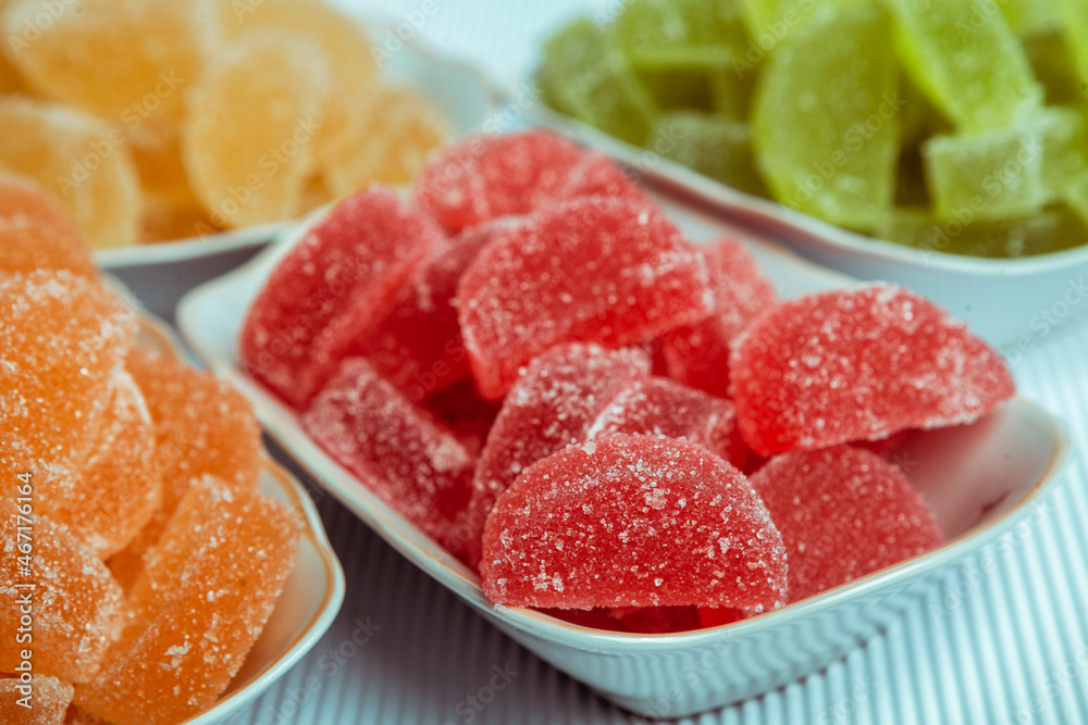 Dessert marmalade in the form of lemon and orange slices. The sweetness of jelly candy. Dessert marmalade in the form of lemon and orange slices. The sweetness of jelly candy.