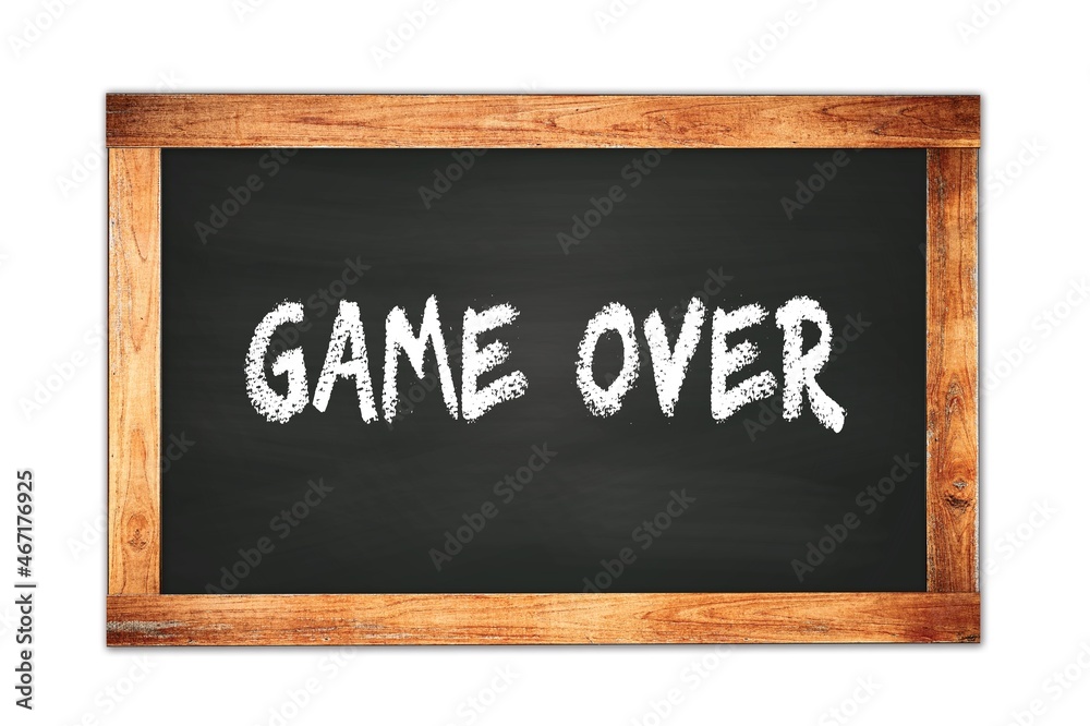 GAME OVER text written on wooden frame school blackboard. GAME OVER text written on wooden frame school blackboard.