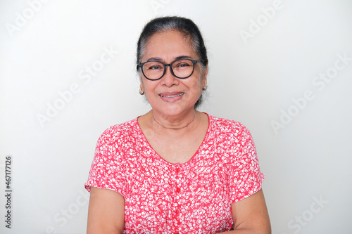 Elderly Asian looking forward and smiling friendly photo