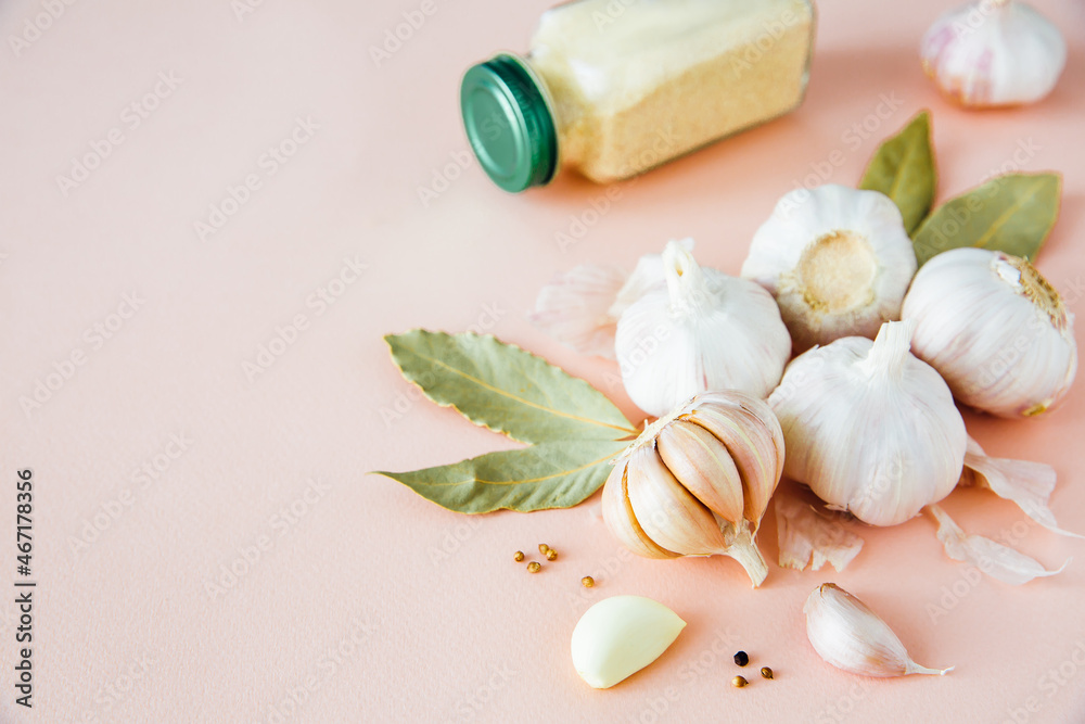Garlic bulbs on a pink background with spices, dried garlic, pepper and bay leaf. Spices and condiments. Food background. Copy space.
Garlic bulbs on a pink background with spices, dried garlic, pepper and bay leaf. Spices and condiments. Food background. Copy space.