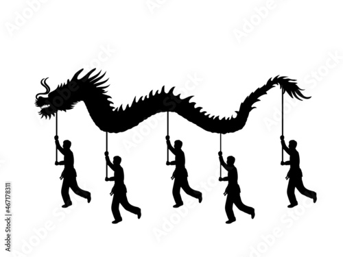 Silhouette of people performing dragon dance for Chinese New Year.