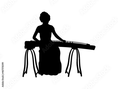 Silhouette of girl playing a stringed musical instrument of east asia. photo