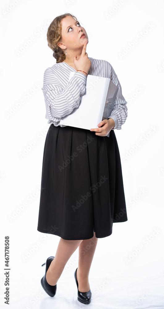 girl studio. model posing at the camera with a book. isolated white background. girl in trousers and blouse, shoes girl studio. model posing at the camera with a book. isolated white background. girl in trousers and blouse, shoes