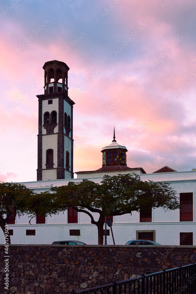 Image of the bell tower of the Church of Our Lady of the Conception in Santa Cruz de Tenerife (Canary Islands, Spain) with a cloudy summer sunset.