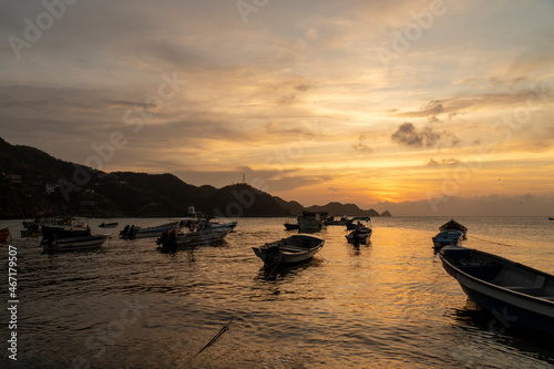 Nature landscape with colorful sunset and boats in the sea. Santa Marta, Magdalena, Colombia. photo