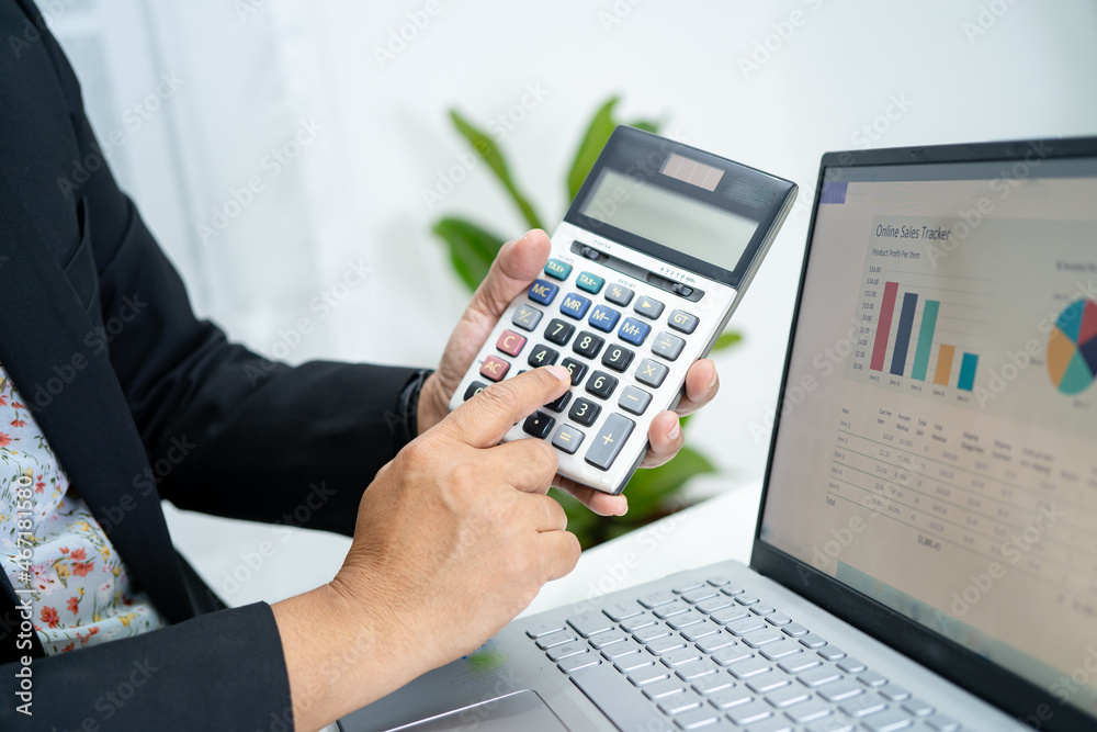 Asian accountant working and analyzing financial reports project accounting with chart graph in modern office, finance and business concept. Asian accountant working and analyzing financial reports project accounting with chart graph in modern office, finance and business concept.
