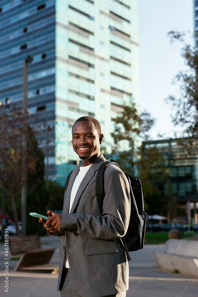Positive black executive man browsing smartphone Positive black executive man browsing smartphone