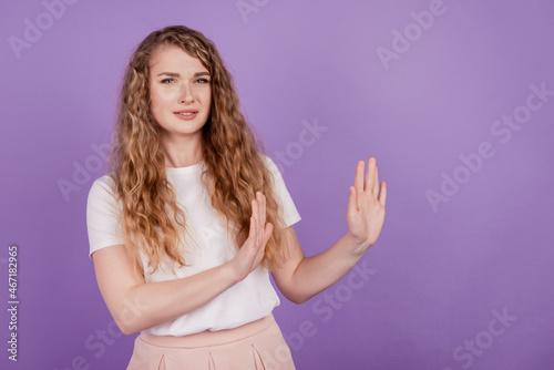 Photo of serious lady show stop ban gesture empty space wear casual outfit on purple background