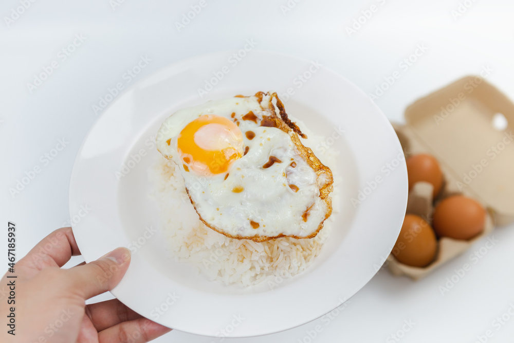 Simple food, rice, fried egg, appetizing on a white background. Simple food, rice, fried egg, appetizing on a white background.