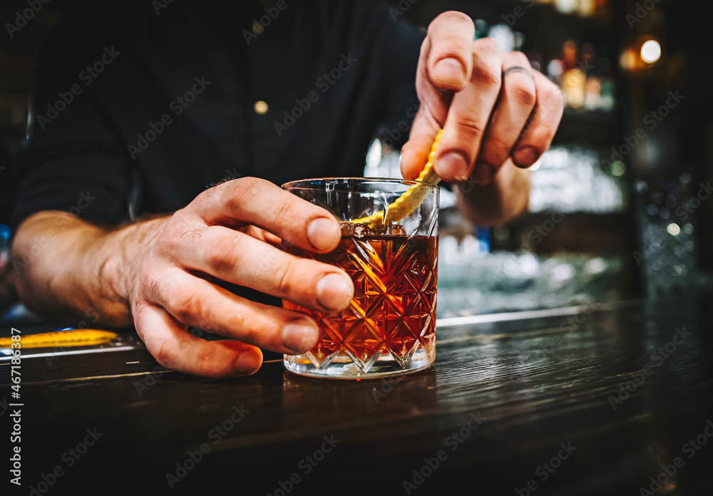 man hand bartender making negroni cocktail in bar