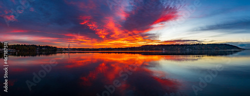 A fiery red and orange sky and reflection on the waters of Lake Washington