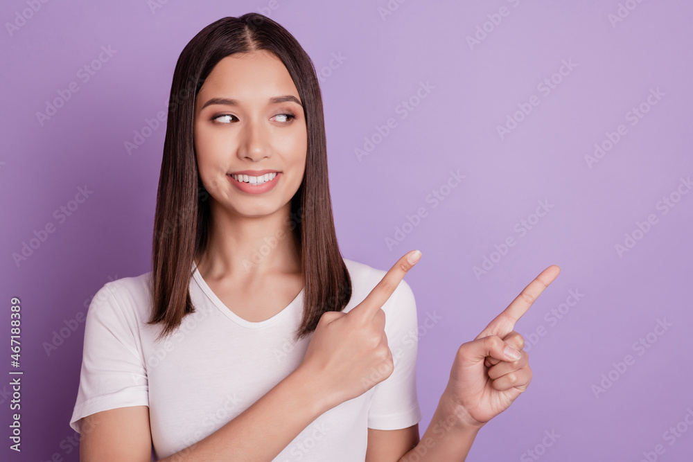 Photo of young cheerful girl look point finger empty space advertising promo choose isolated on violet color background Photo of young cheerful girl look point finger empty space advertising promo choose isolated on violet color background