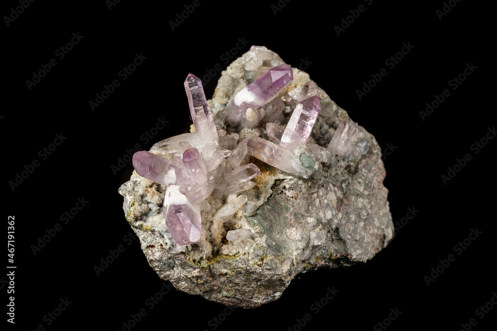 Macro mineral stone Amethyst crystals in rock on a black background Macro mineral stone Amethyst crystals in rock on a black background