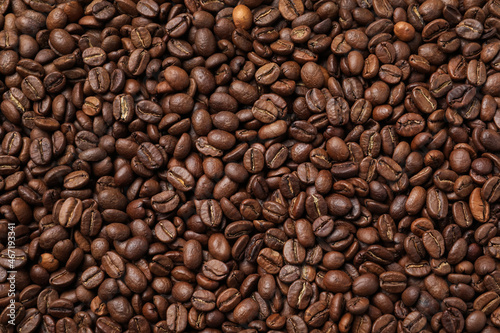 Pile of roasted coffee beans as background, top view