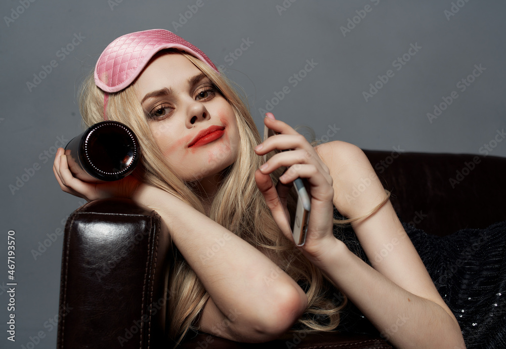 Fototapeta premium cheerful woman lies on the sofa alcohol emotions sleep mask