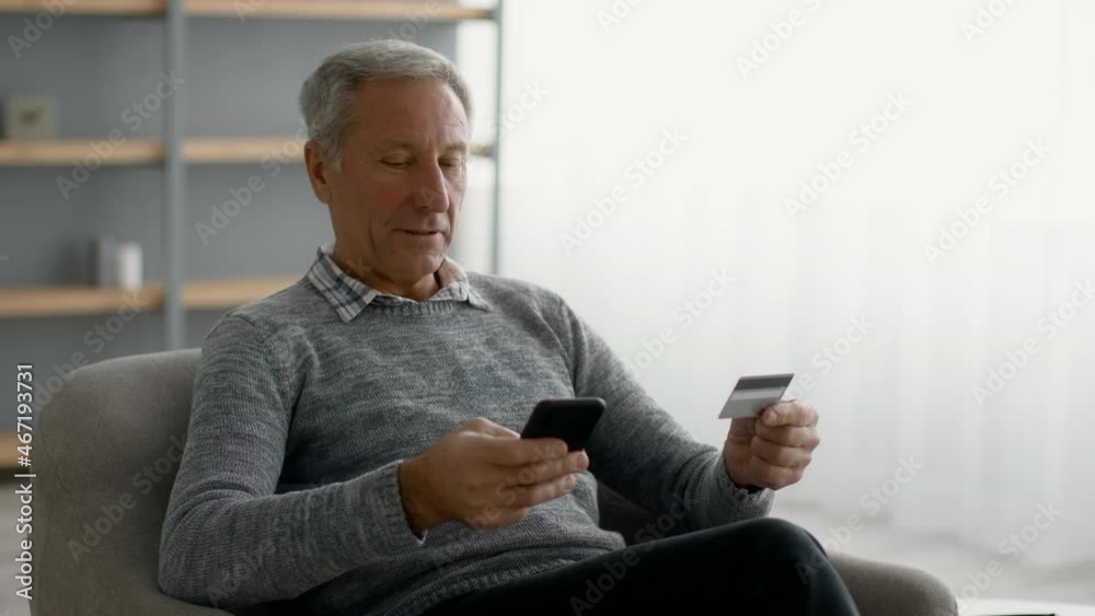 Senior man using smartphone and credit card at home for online shopping Senior man using smartphone and credit card at home for online shopping
