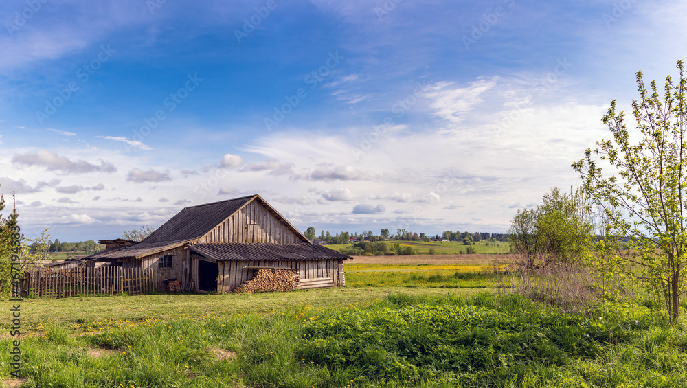 a village house in a field. Russian hut