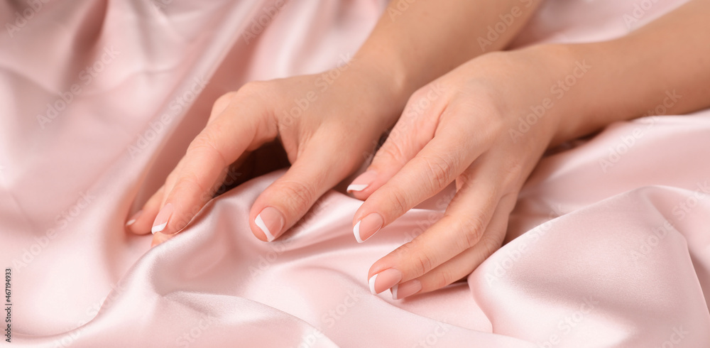 Woman touching smooth silky fabric, closeup view Woman touching smooth silky fabric, closeup view