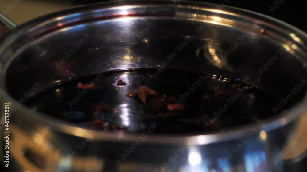 Cooking mulled wine in a saucepan with spices Cooking mulled wine in a saucepan with spices