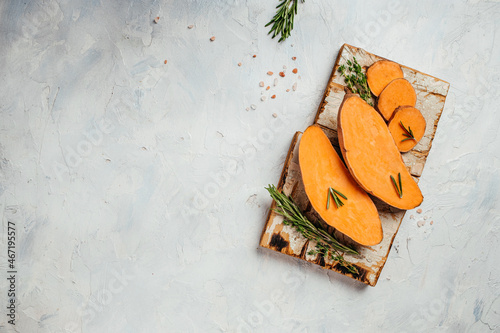 Raw sweet potatoes or batatas on light background. banner, menu, recipe place for text, top view photo