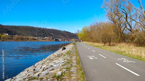 Cycling road next to the beautiful river side of Vltava river in Prague during beautiful weather.