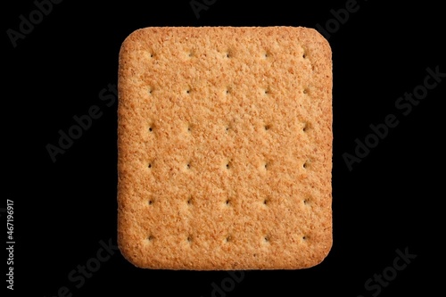 single square shaped biscuit on black background, top view, selective focus