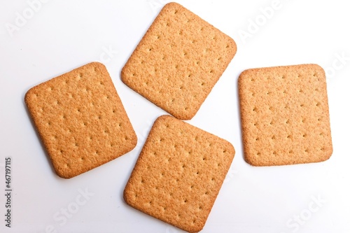 four square shaped biscuit on white background, top view, selective focus