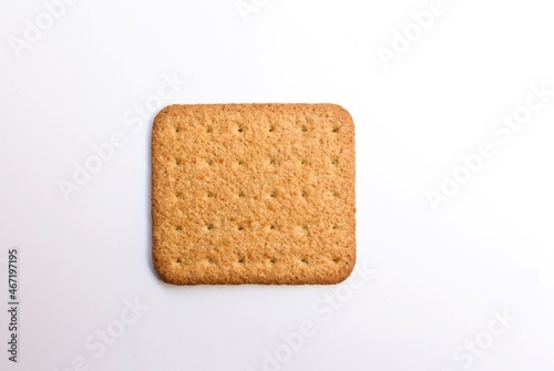 a single biscuit on white background, top view. selective focus