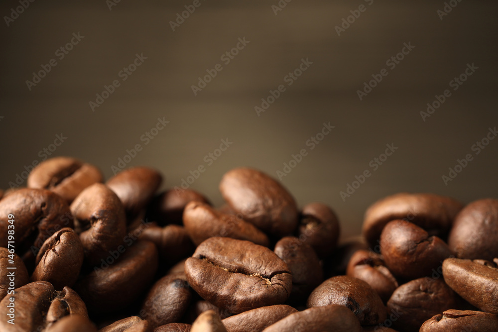 Fototapeta premium Heap of aromatic roasted coffee beans, closeup