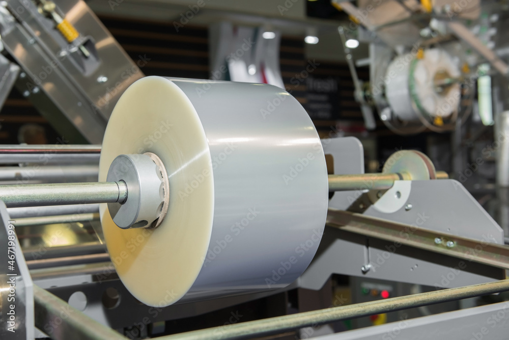 Fototapeta premium Roll of packaging plastic film on shaft