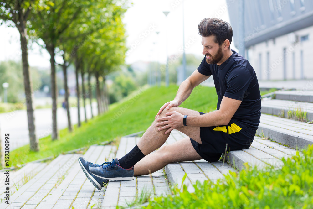 Athlete male injured during training, has severe leg pain, muscle aches