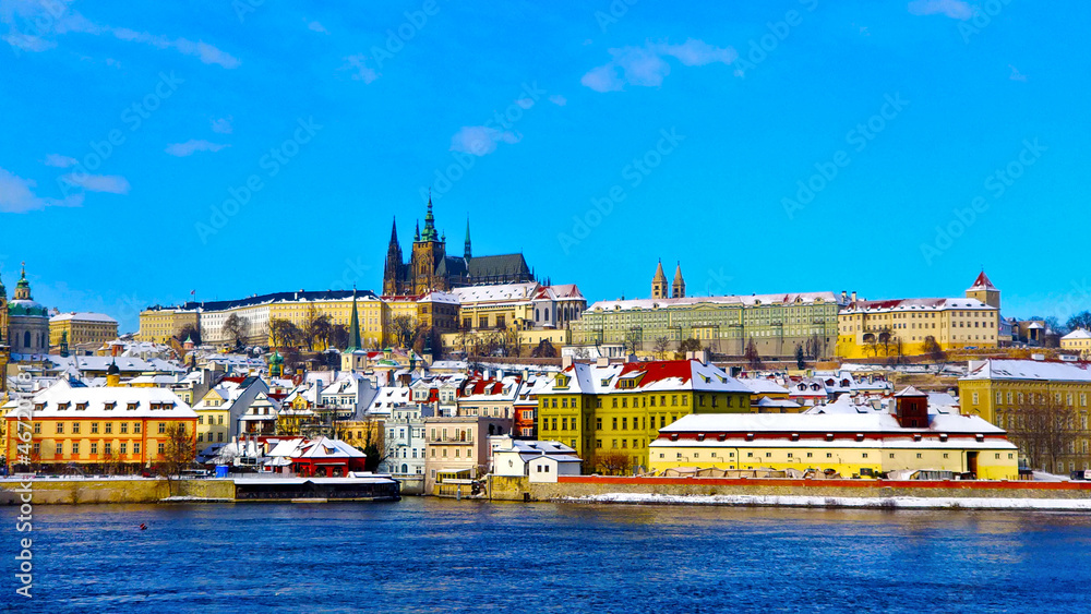 Prague castle with New Town during freezing winter and beautiful blue sky. All the roofs are covered with snow.