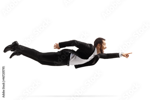 Full length shot of a professional man in a suit and tie flying and pointing