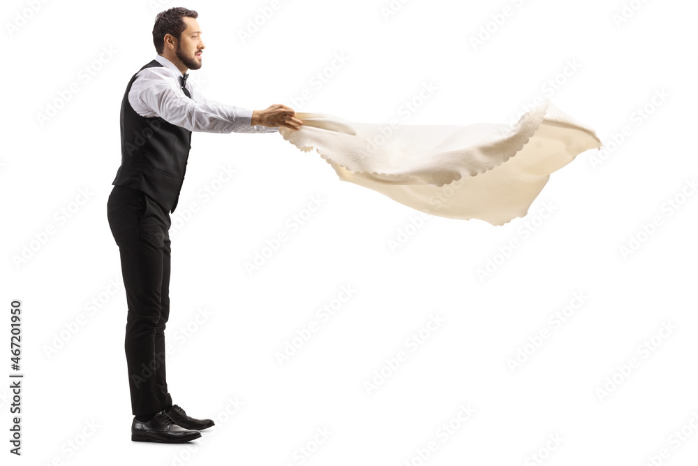 Full length profile shot of a server holding a tablecloth