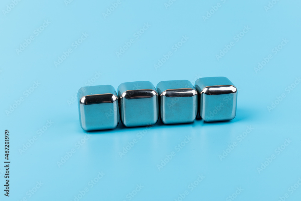 stainless steel ice cubes whiskey stones on blue background stainless steel ice cubes whiskey stones on blue background