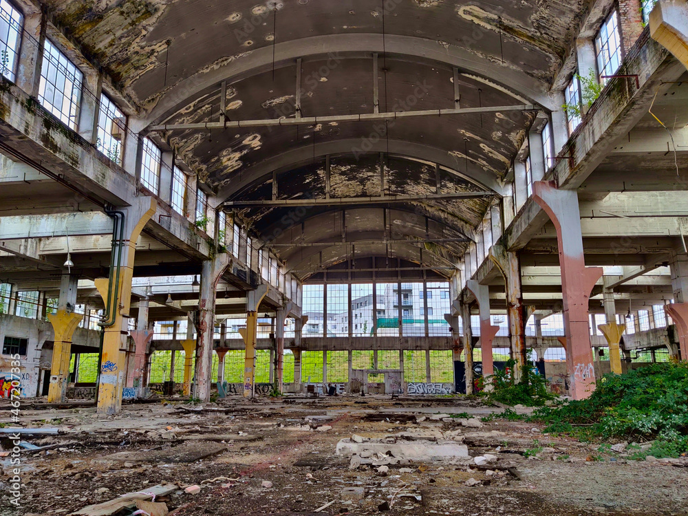 Abandoned factory building seeing from inside made of steel and concrete with missing windows. There is a lot of mess inside. Abandoned factory building seeing from inside made of steel and concrete with missing windows. There is a lot of mess inside.