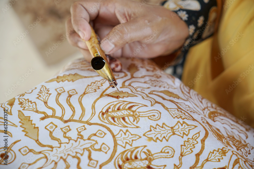The process of making batik. Batik is a handmade traditional art from  Indonesia. Produced by technique of wax-resist dyeing applied to fabric.  Stock Photo | Adobe Stock