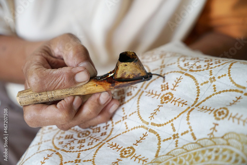 The process of making batik. Batik is a handmade traditional art from Indonesia. Produced by technique of wax-resist dyeing applied to fabric. photo