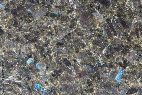 Closeup of granite, an igneous rock with phaneritic texture in which mineral grains are visible with the unaided eye. Elegant granite slab texture for background photo