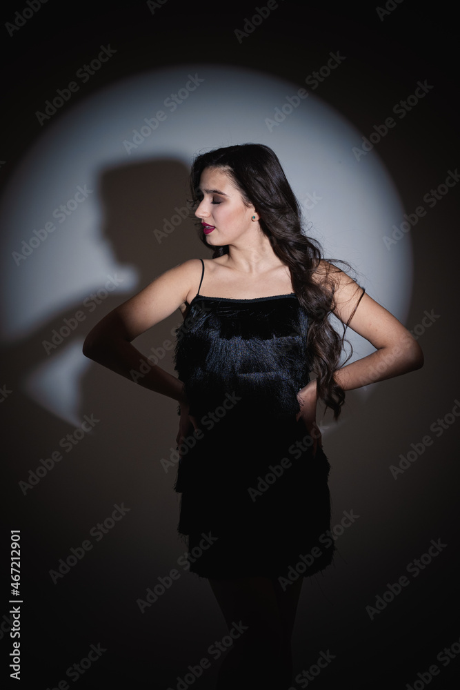 Girl in a cocktail dress. Young girl with luxurious hairstyle and makeup. Photo of the singer before the concert. Girl in a cocktail dress. Young girl with luxurious hairstyle and makeup. Photo of the singer before the concert.