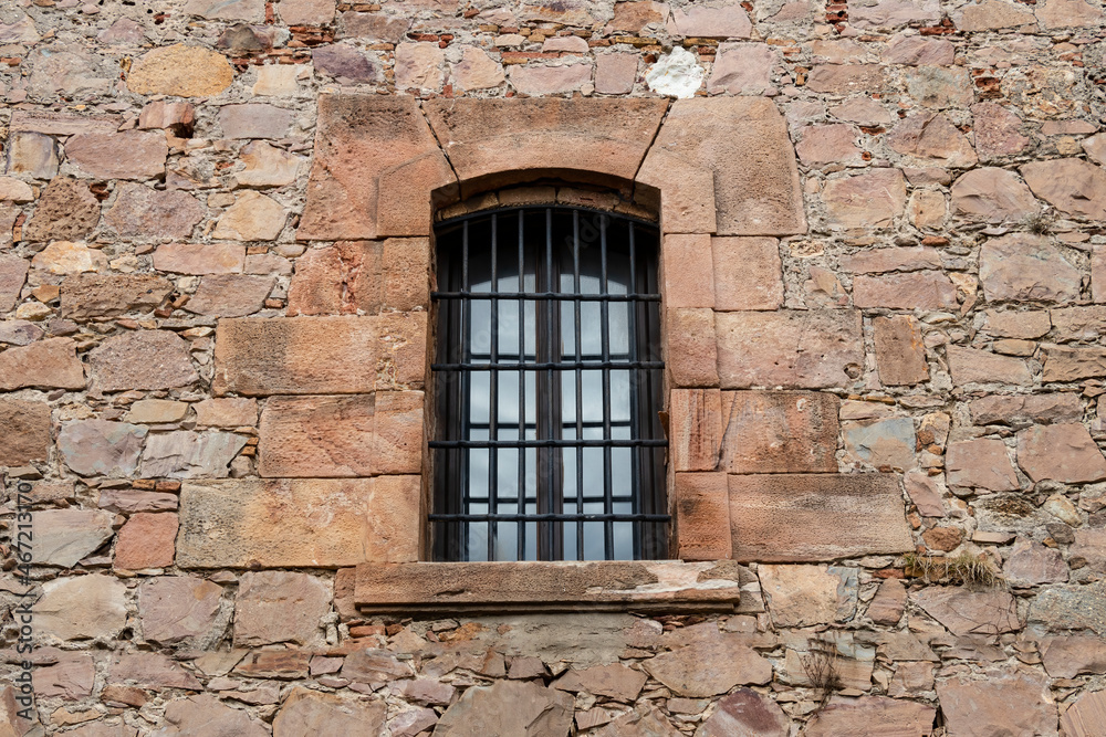 Old rock wall with vintage window for texture