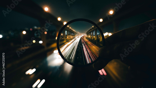 Long shot photo of car on road through lens