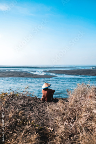 Man sitting on river bank