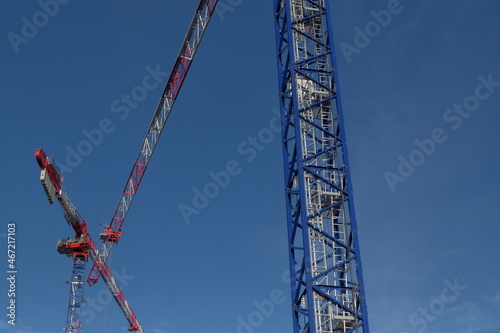 Red and blue cranes under blue sky photo