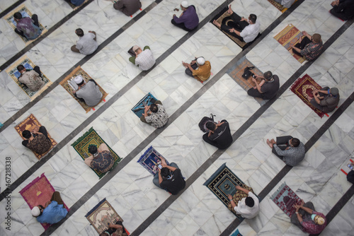 Top view of muslim men praying and social distancing in mosque photo