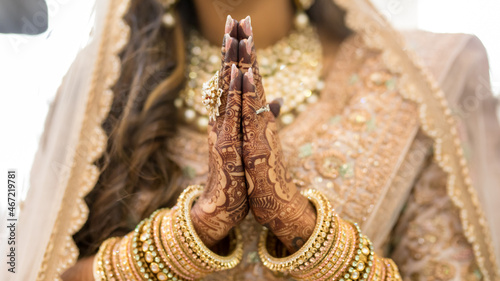Woman in golden cultural outfit and jewelry with Mehndi tattoo